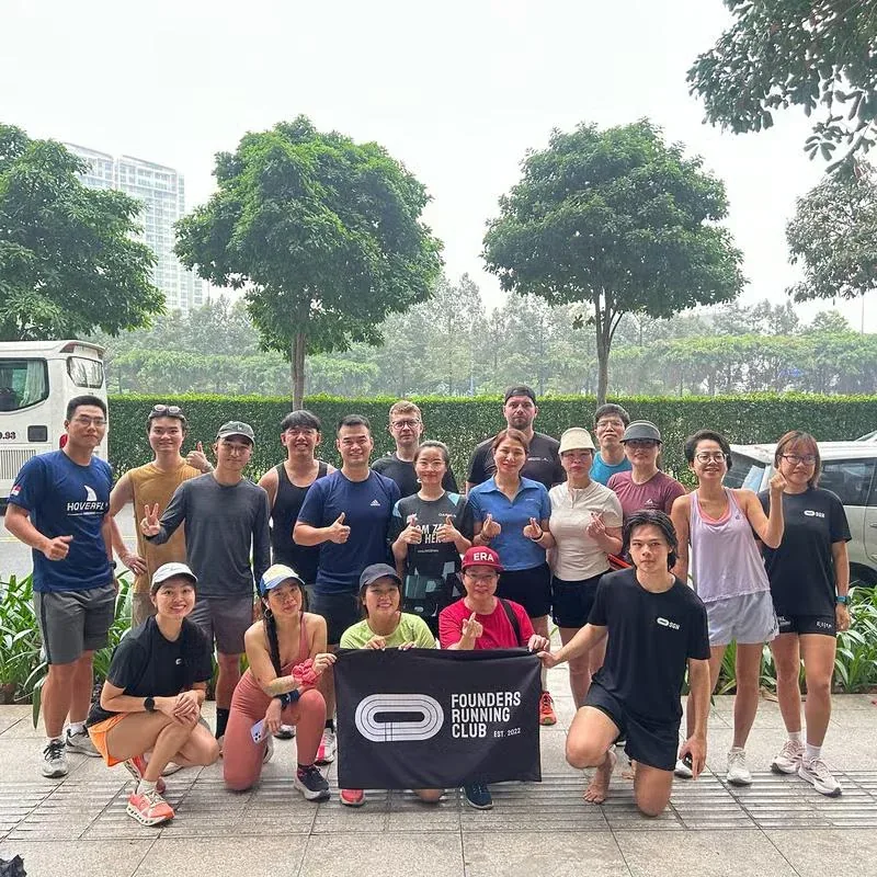 Founders Running Club runners pose with the club banner in Ho Chi Minh City; promotional group photo, not a photo of the October 31 run.
