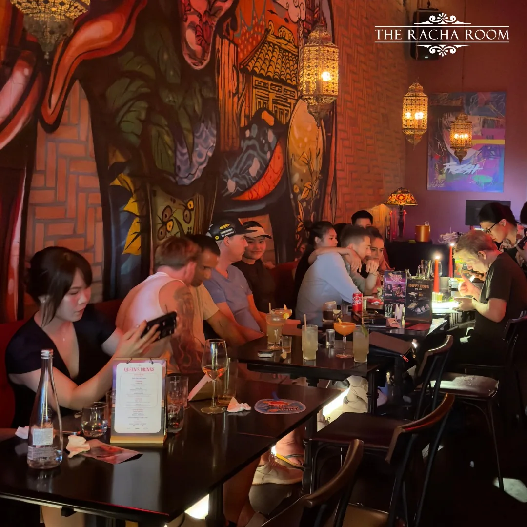 The Racha Room dining space at 105–107 Xuan Thuy, with its mural, pendant lights and tables.