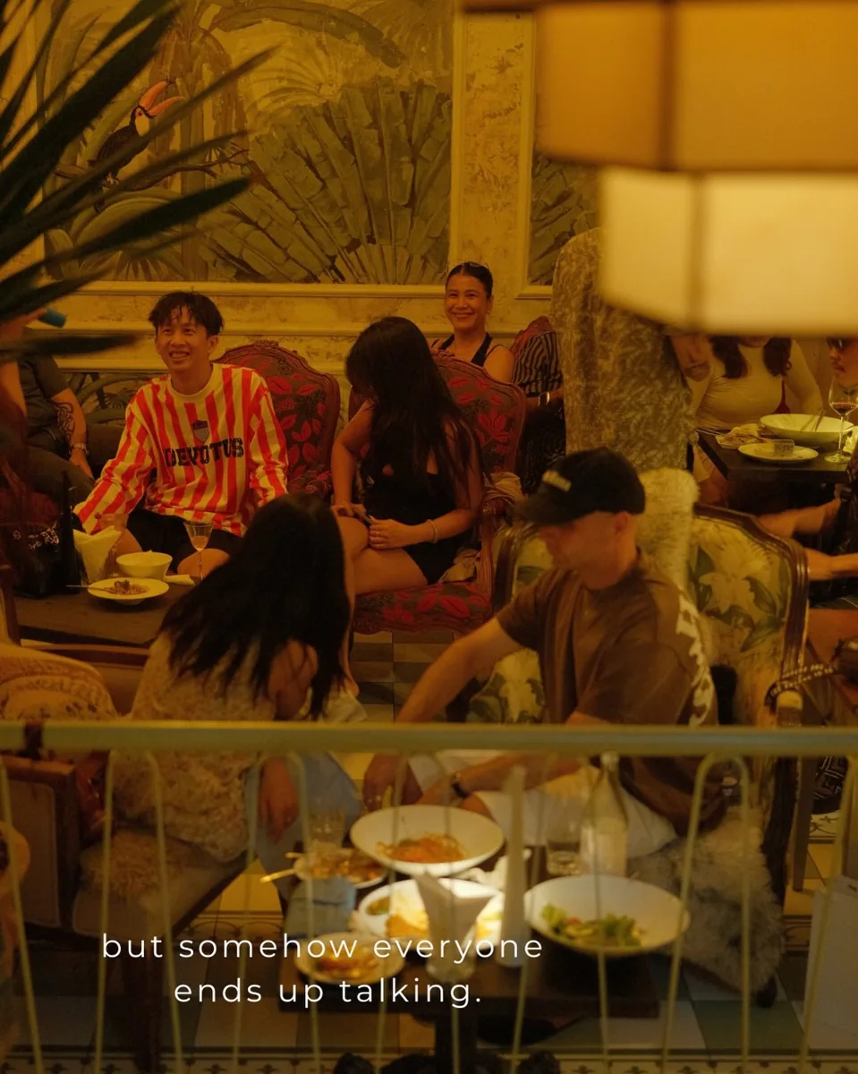 Guests chatting in the warmly lit interior of Lulu Bar & Eatery at 1A Phan Tôn.