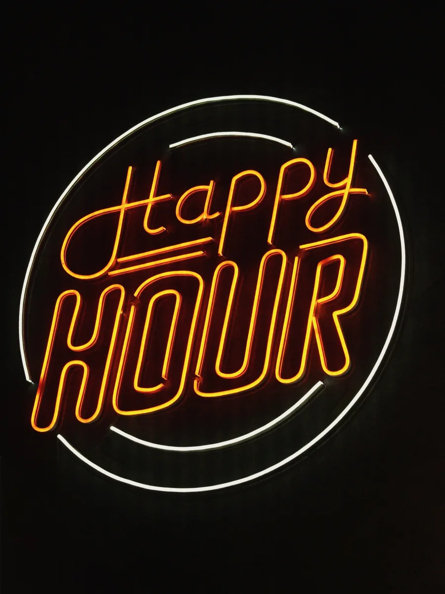 Happy Hour neon sign at Symposium Bar