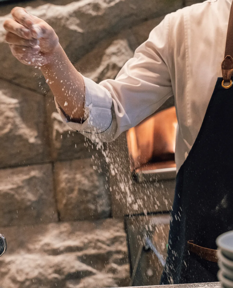 Chef shaping and topping pizza dough at Basilico, from the organizer’s pizza-making announcement.