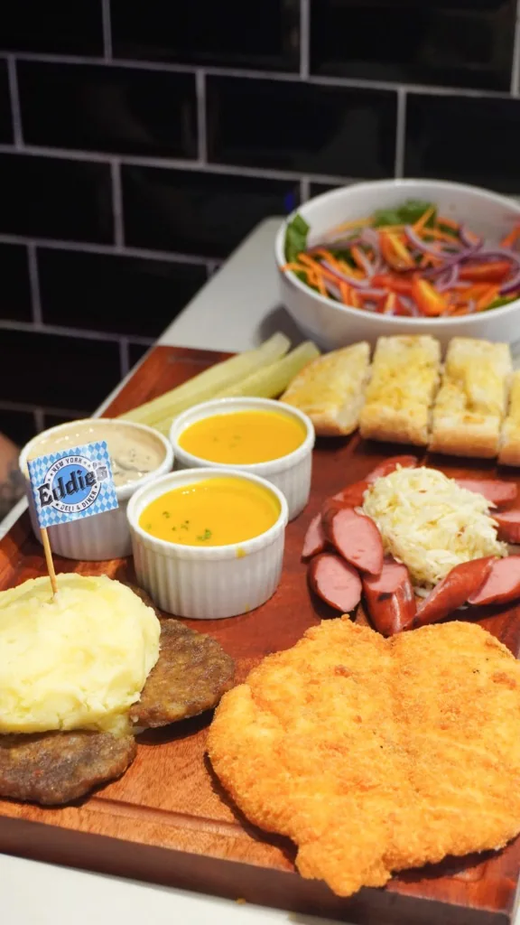 Oktoberfest sharing platter with schnitzel, sausages, mash, soup and bread.