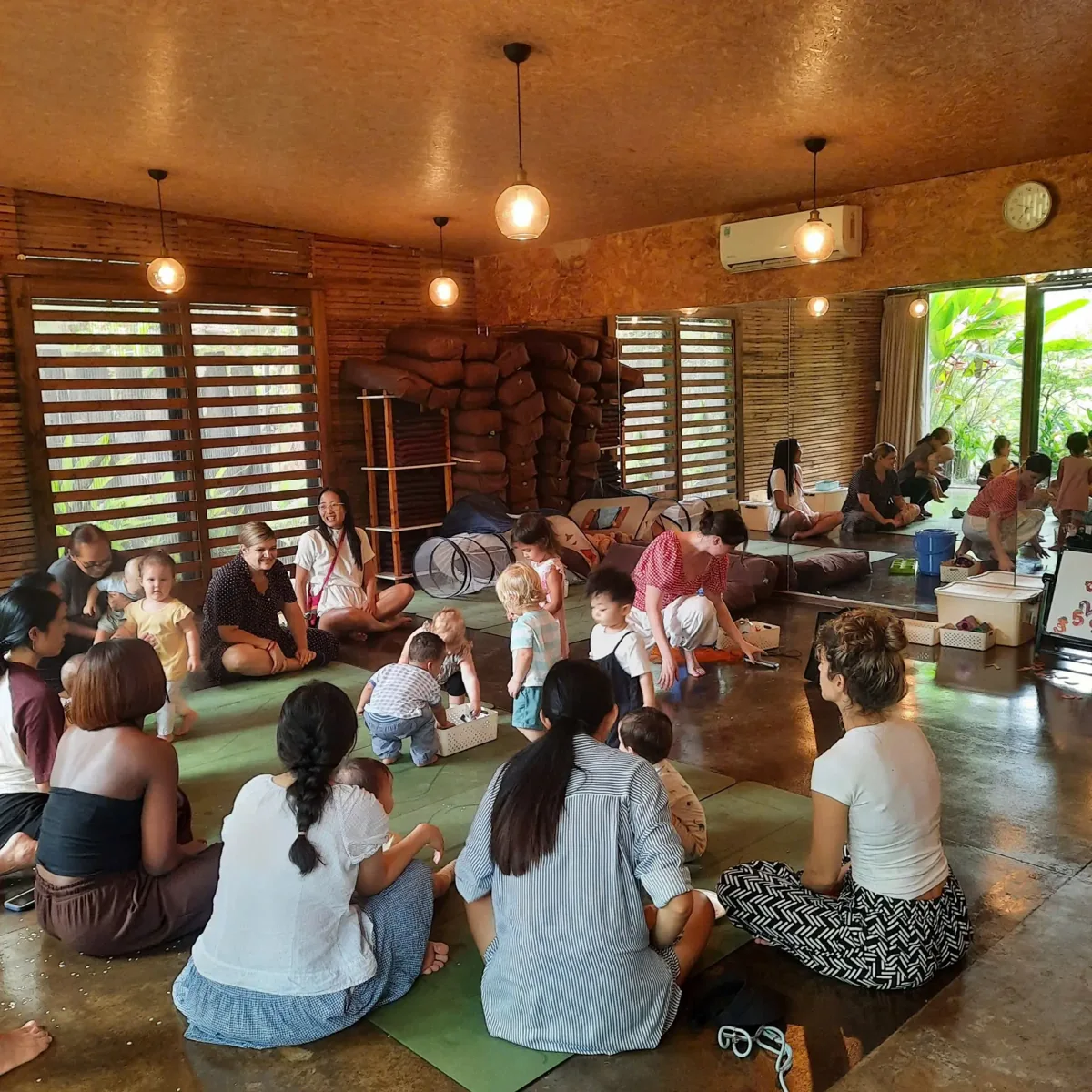 Adults and toddlers at an Anh's Playgroup session in the Yoga Pod studio
