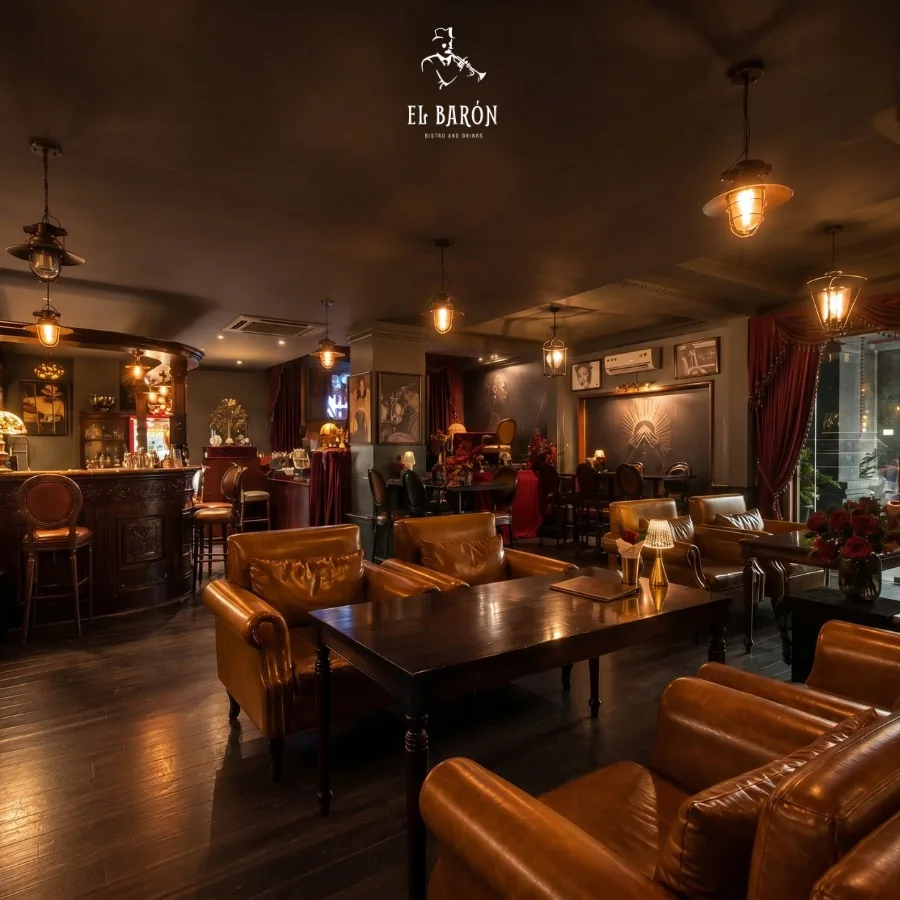 El Barón lounge at 42 Hưng Phước 4, with leather seating, warm pendant lighting and the bar