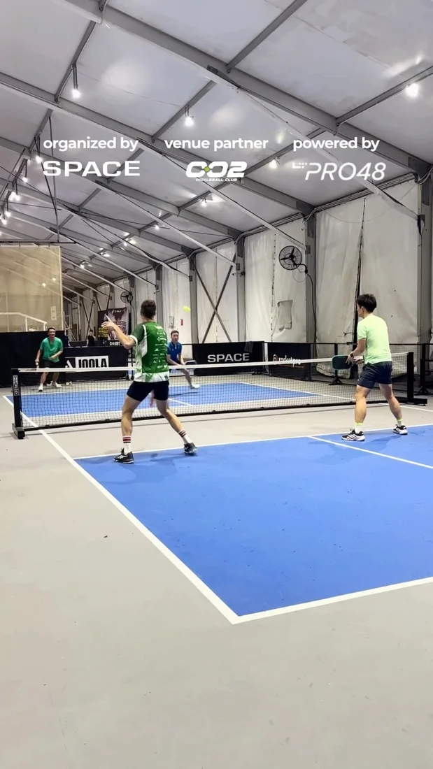 Players on the covered courts at 002 Pickleball Club.